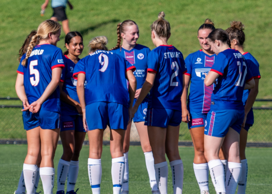 Manly United have a pre-match huddle before their trial game against Illawarra Stingrays. Photo credit: Jeremy Denham