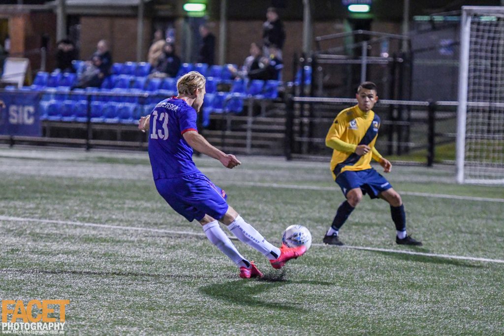 Scott Balderson fires at goal during a 2020 NPL NSW Men's game between Manly United and North Shore Mariners. Our own Jesse Piriz is in the background! Photo credit: Jeremy Denham