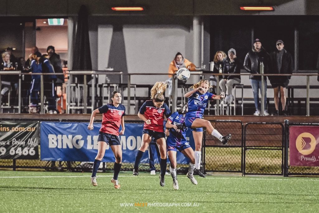 Action from the 2022 Round 9 NPL NSW Women's game between Manly United and Sydney University at Cromer Park. Photo credit: Jeremy Denham