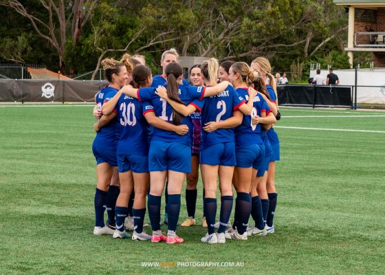 Manly United huddle before their NPL NSW Women's Round 3 game against Gladesville Ravens at Christie Park. Photo credit: Jeremy Denham