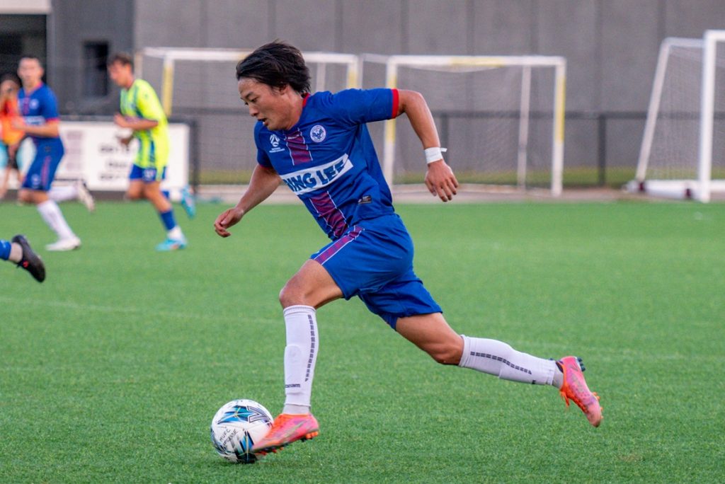 Seiya Kambayashi runs with the ball during the 2023 Round 2 NPL NSW Men's match between Manly United and Sydney Olympic at Cromer Park. Photo credit: Jeremy Denham