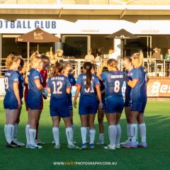 Manly United huddle before their 2023 NPL NSW Women's Round 6 game against Northern Tigers at Cromer Park. Photo credit: Jeremy Denham