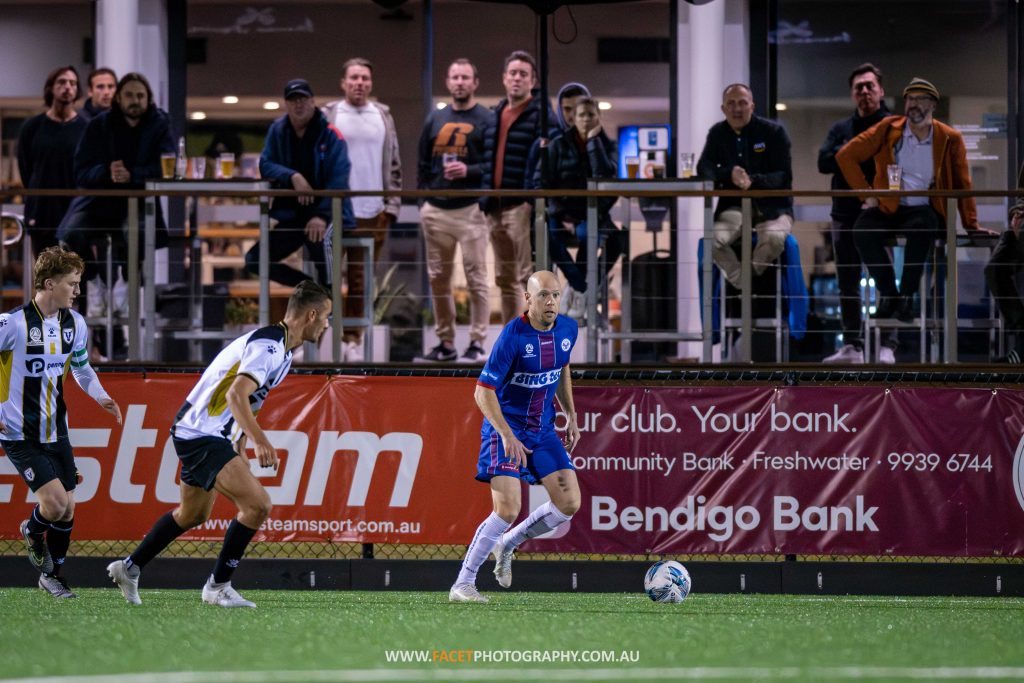 Matt Sim scans for options during the 2023 NPL NSW Men's Round 15 game between Manly United and Bulls FC Academy at Cromer Park. Photo credit: Jeremy Denham