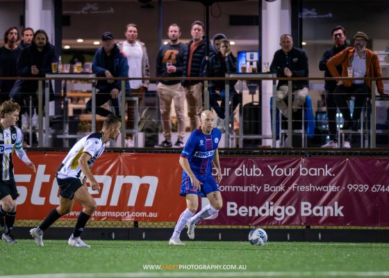 Matt Sim scans for options during the 2023 NPL NSW Men's Round 15 game between Manly United and Bulls FC Academy at Cromer Park. Photo credit: Jeremy Denham