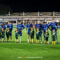 Manly United line up with mascots from Curl Curl before their 2023 NPL NSW Men's Round 23 game against Marconi Stallions at Cromer Park. Photo credit: Jeremy Denham