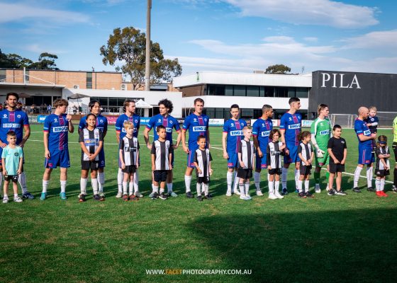 Manly United line up with mascots from Narrabeen before their 2023 NPL NSW Men's Round 28 game against Western Sydney Wanderers. Photo credit: Jeremy Denham